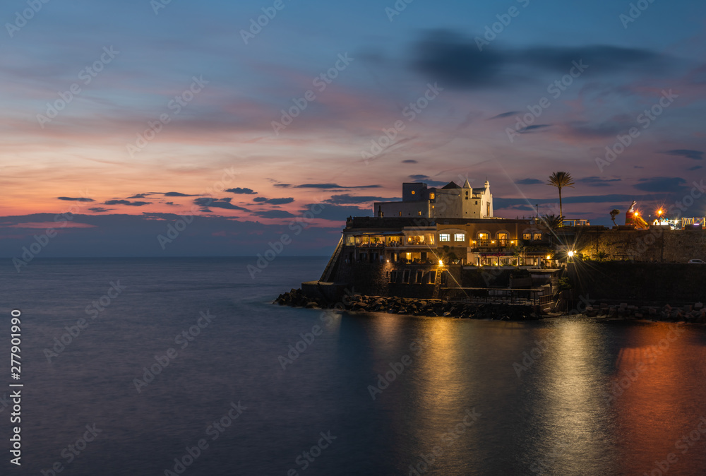 Church of Soccorso and reflections in the sea at sunset. Italy, Ischia. Copy space