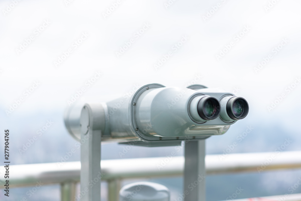 telescope with city skyline