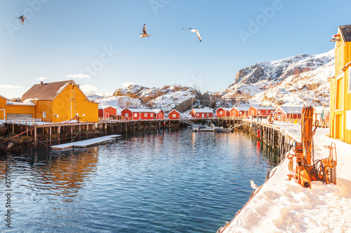 Traditional and very old fishing village - Nusfjord on Lofoten Islands archipelago in Norway, Scandinavia, Europe. Picturesque landscape of northern polar settlement. Traditional wooden houses rorbu. photo