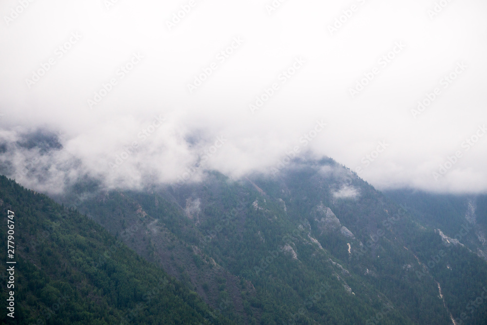 mountain peaks in misty clouds