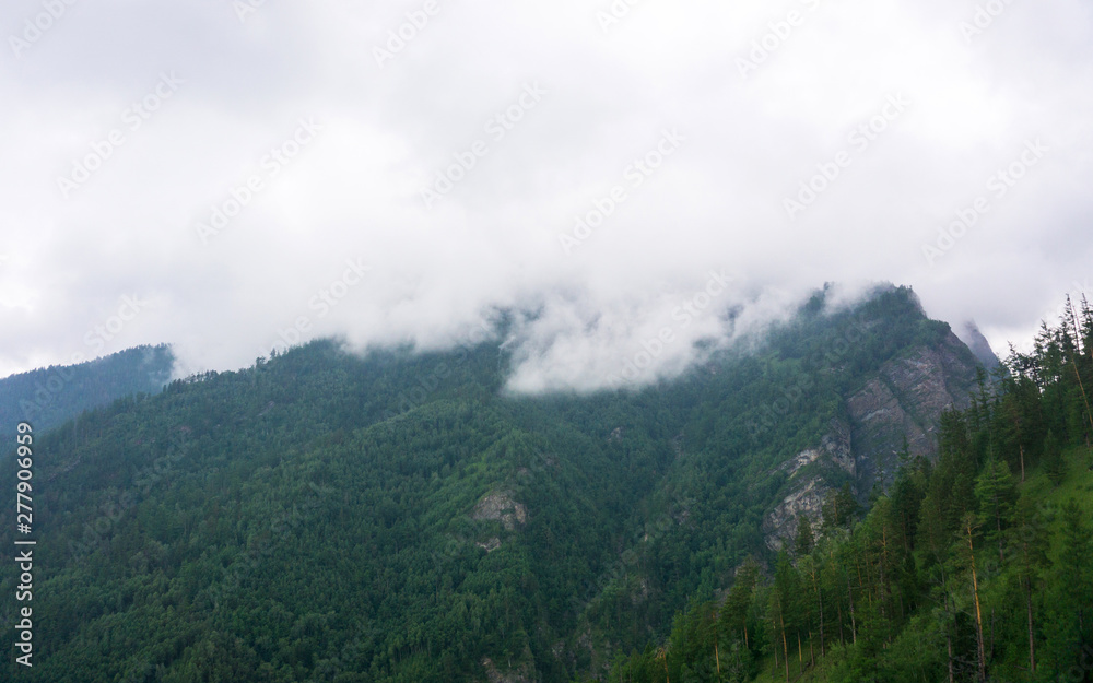 mountain peaks in misty clouds