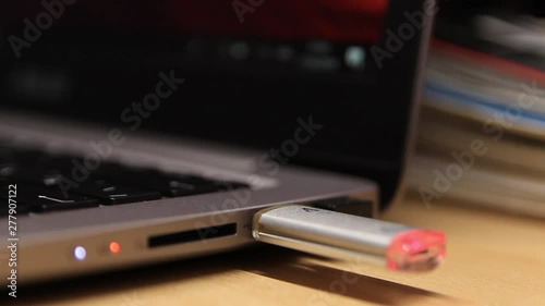 Insert a flash drive in a laptop. Close-up. A laptop. Technology.