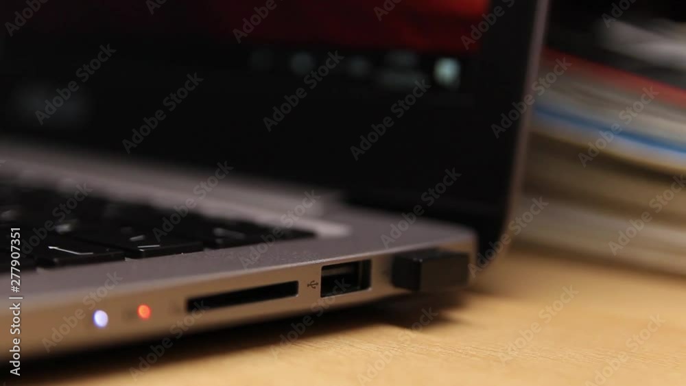 Removing a flash drive from a laptop. Close-up. A laptop. Technology.
