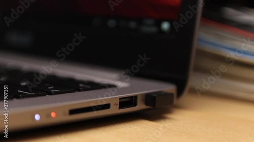 Removing a flash drive from a laptop. Close-up. A laptop. Technology.