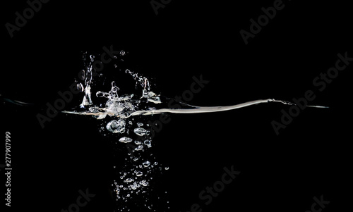 Splash on water surface isolated on black background. Water bubbles and rippling close up. Background for overlays design, screen blending mode layer