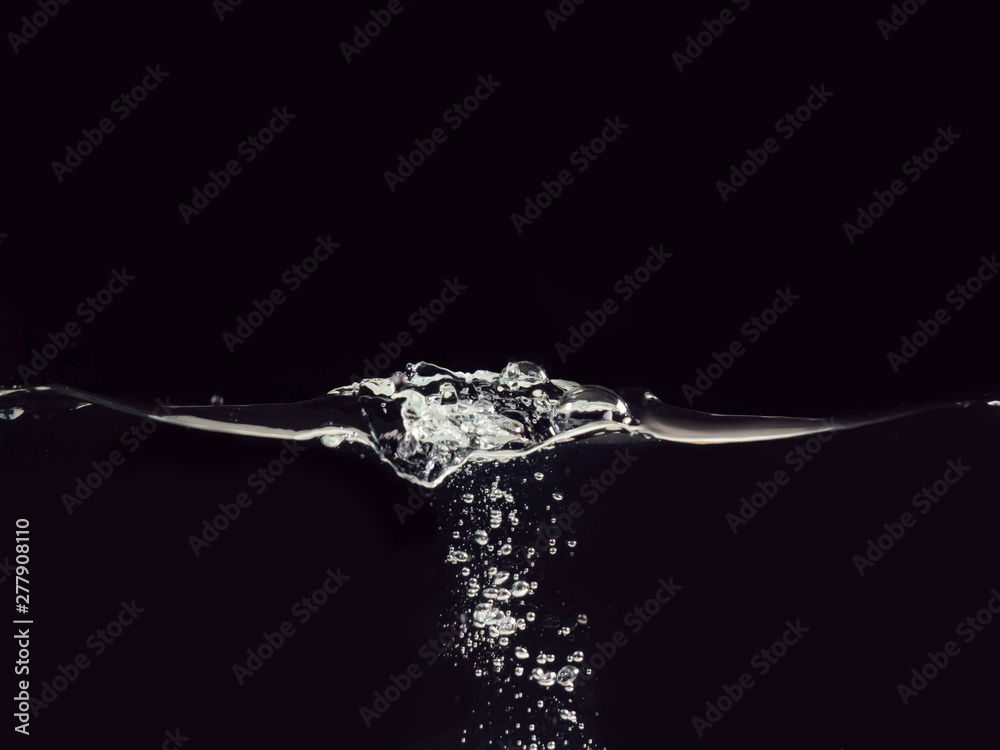 Droplet of water dropped into liquid isolated on black background, close up view. Rippling surface and bubbles underwater. Abstract background for overlays design, screen blending mode layer Droplet of water dropped into liquid isolated on black background, close up view. Rippling surface and bubbles underwater. Abstract background for overlays design, screen blending mode layer