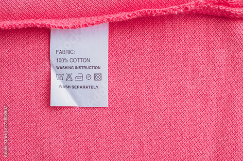 White laundry care washing instructions clothes label on cotton shirt photo