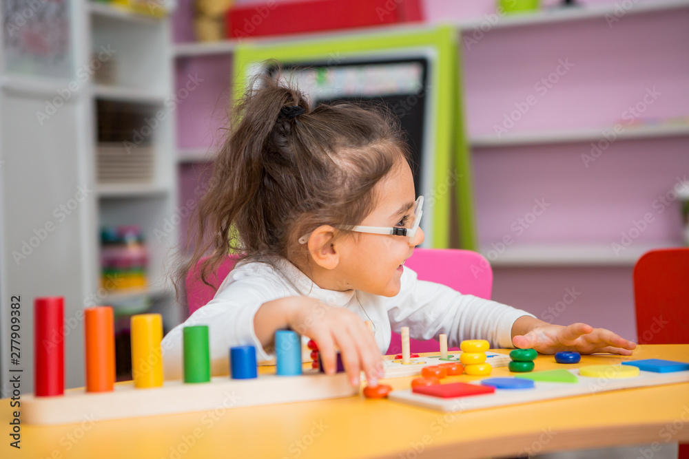 child girl with glasses for vision plays in educational classes child girl with glasses for vision plays in educational classes