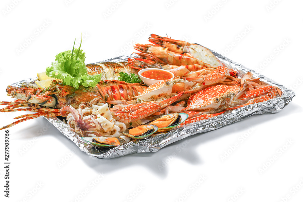 Grilled Mixed Sea-food Platter Set contain Lobster, Fish, Blue Clab, Big Prawn, Mussel Clam and Calamari Squid with piece of lemon & vegetable isolated on white background with shadow, High angle view Grilled Mixed Sea-food Platter Set contain Lobster, Fish, Blue Clab, Big Prawn, Mussel Clam and Calamari Squid with piece of lemon & vegetable isolated on white background with shadow, High angle view