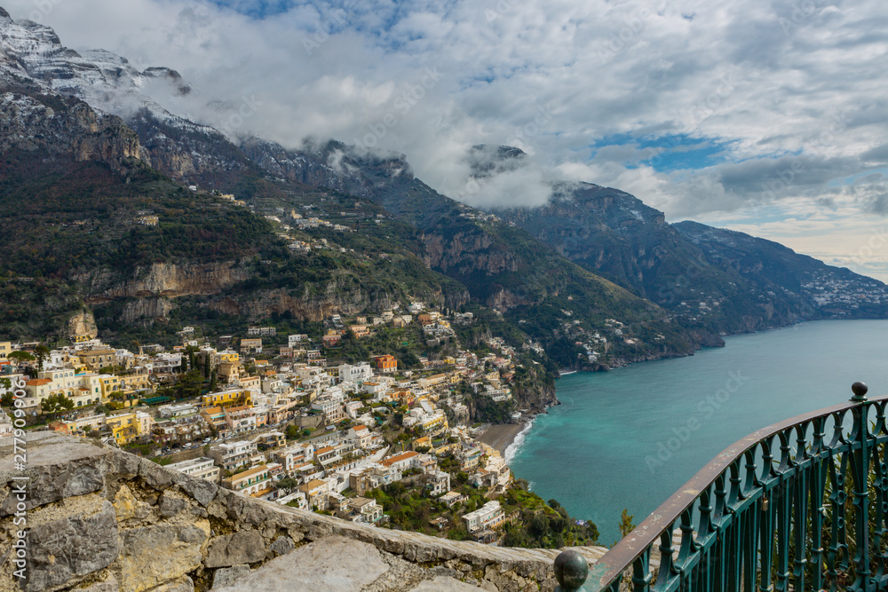 Positano on the Amalfi coast,  Italy in wintertime with a mountain range in the background covered with snow