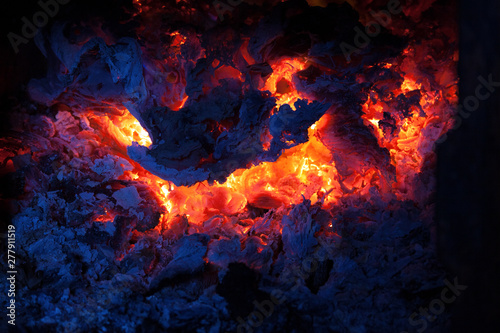burned fire in the furnace, coals and open fire at night