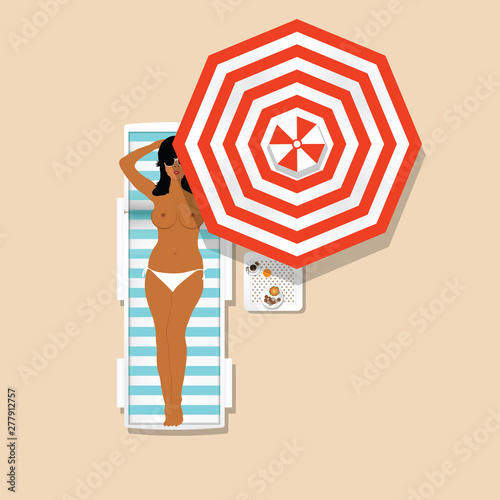 girl in white bikini resting on the deckchair with umbrella