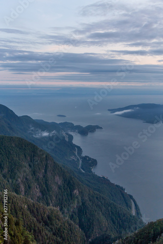 Beautiful View of Canadian Mountain Landscape covered in clouds during a vibrant summer sunset. Taken on top of St Mark's Summit, West Vancouver, British Columbia, Canada. © edb3_16