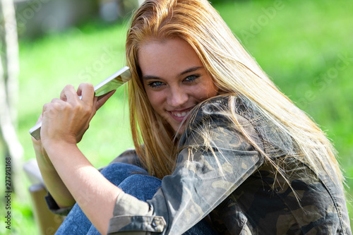 Quadro em tela Fun coy young woman grinning at the camera