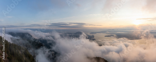 Beautiful Panoramic View of Canadian Mountain Landscape covered in clouds during a vibrant summer sunset. Taken on top of St Mark's Summit, West Vancouver, British Columbia, Canada.