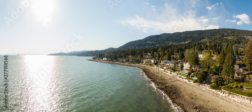 Fototapeta Naklejka Na Ścianę i Meble -  Aerial Panoramic View of a rocky beach in the modern city during a vibrant sunny day. Taken in West Vancouver, British Columbia, Canada.