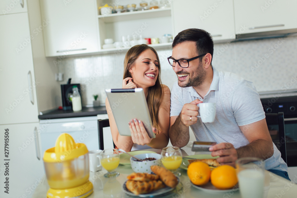 Couple buying online on the interent with a credit card.