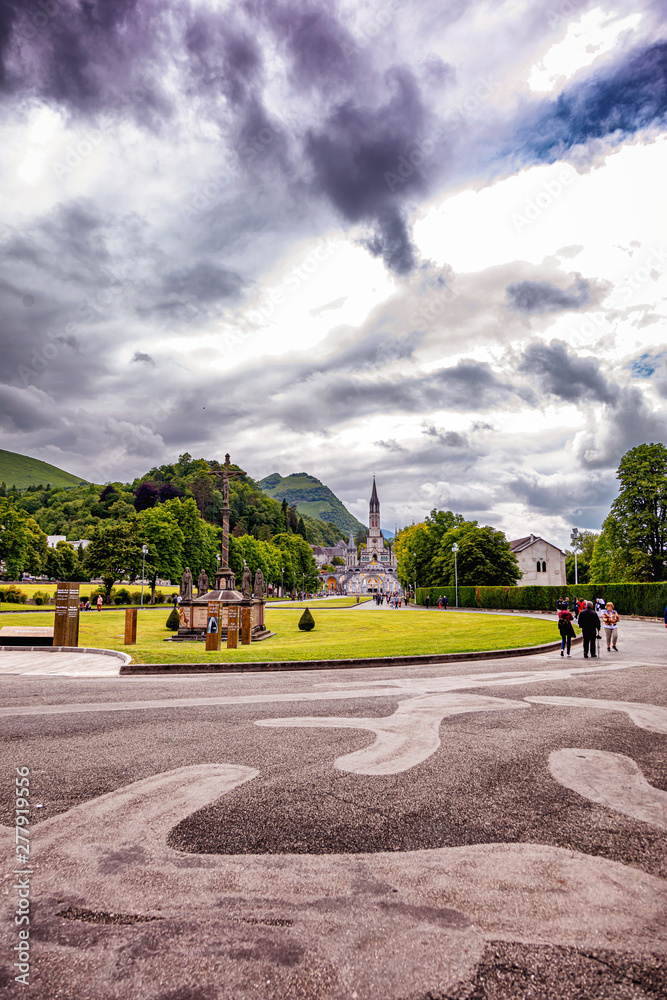 Obraz premium Christian cross on a background the Basilica of our Lady of the Rosary in Lourdes, France