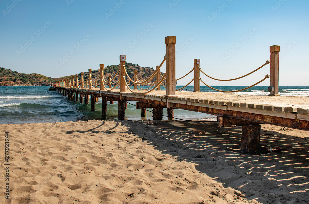 Scene at Tropical holiday vacation Beach Resort with wooden pier and rope