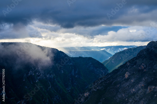 Montenegro, Spectacular weather contrast of dramatic sky full of clouds and sunrays shining through fog over tara river canyon nature landscape in durmitor national park near zabljak