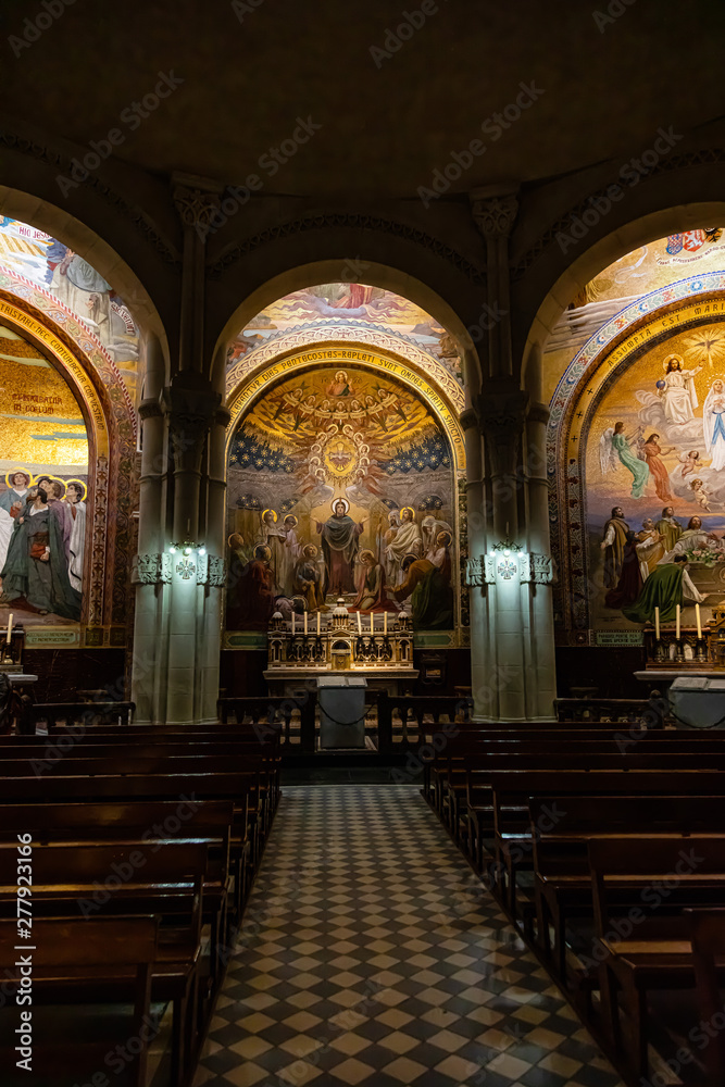 Chapel inside the Rosary Basilica in Lourdes displaying Christian murals