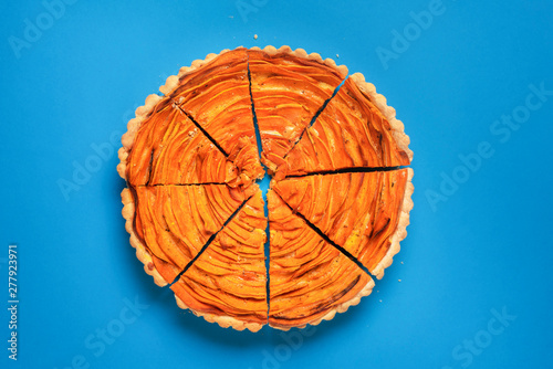 Sliced sweet potato tart on blue background