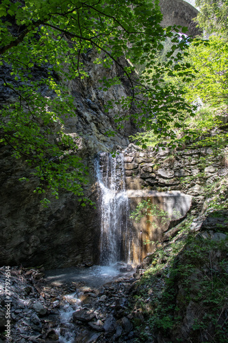 View of a waterfall with long exposure and motion blur of water in the swiss alps