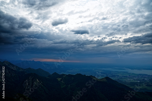 Dramatic sunset mountain sky with storm clouds and view of Chiemsee in Bavaria