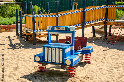 Various wooden playground equipment on a public playground in Berlin with the theme police and rescue. photo