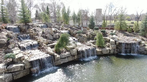 Aerial view of 3 waterfalls flowing into a pond