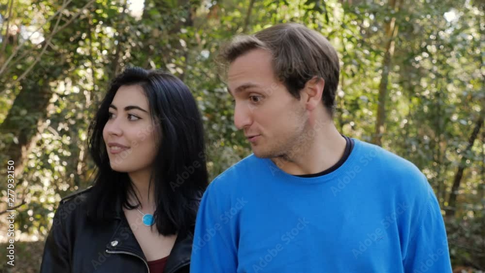 Young woma Refusing Mans Kiss during first date in the park.Friend zone,refusal Young woma Refusing Mans Kiss during first date in the park.Friend zone,refusal