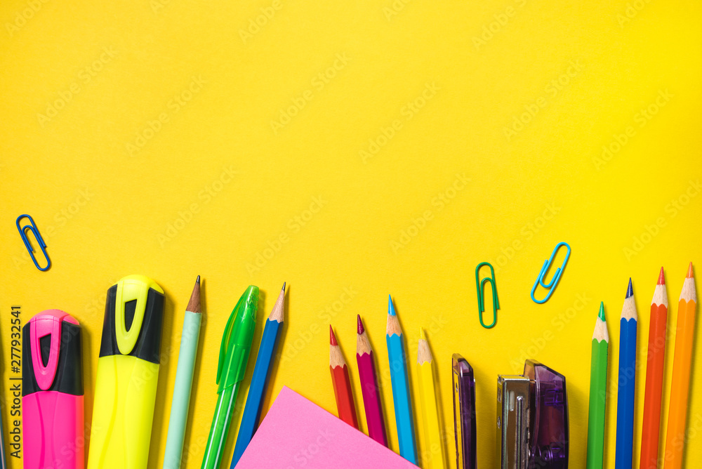 Fototapeta premium School supplies on yellow background. Top view. Copy space.