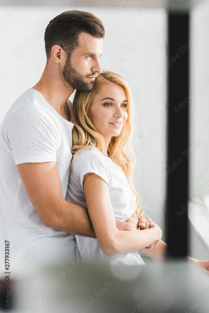 selective focus of beautiful couple hugging at home selective focus of beautiful couple hugging at home