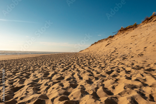 Sandy beach with blue sky taken from a low position