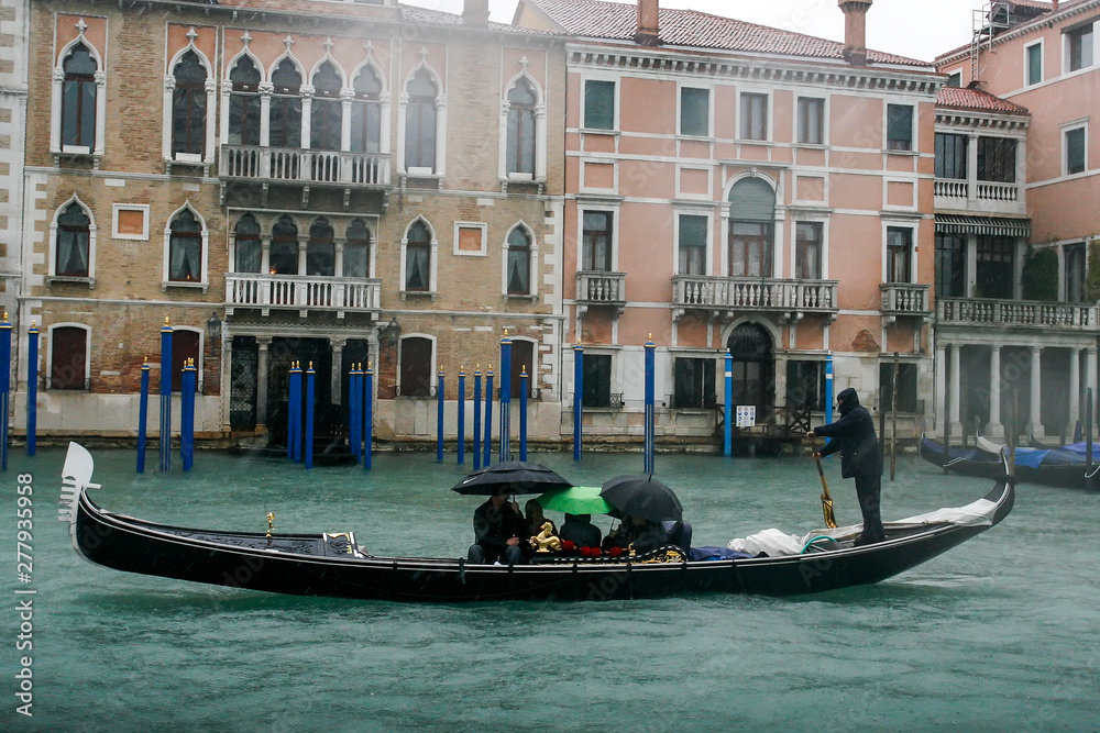 Gondolier on gondola on the Grand Canal in Venice, Italy. April 2012  Rainy day