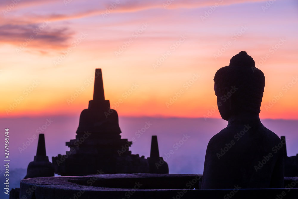 Buddha statue at sunrise, Borobudur temple complex, Borobudur, Yogyakarta, Java, Indonesia