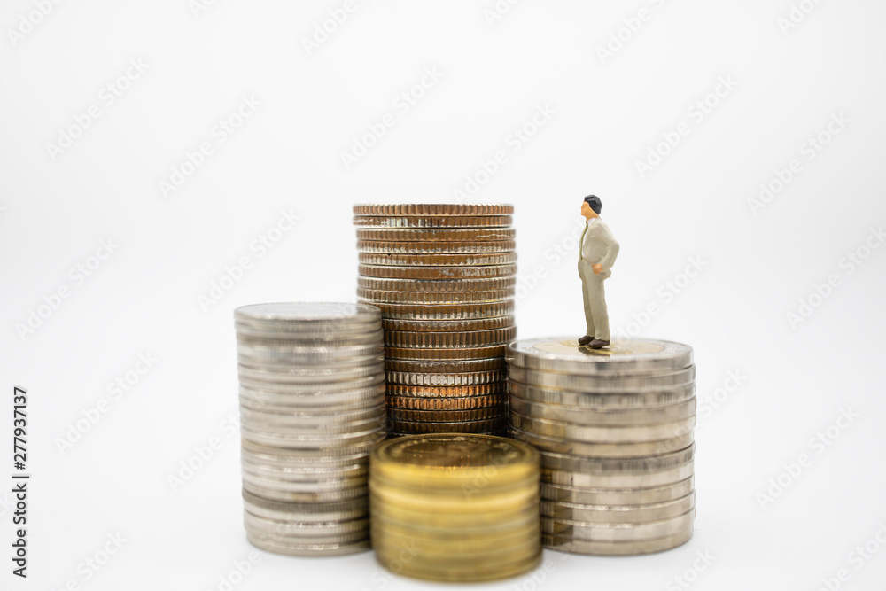 Business, Finance, Saving and secure concept. Close up of businessman minature figures standing on stack of coins and looking to highest stack on white background and copy space.