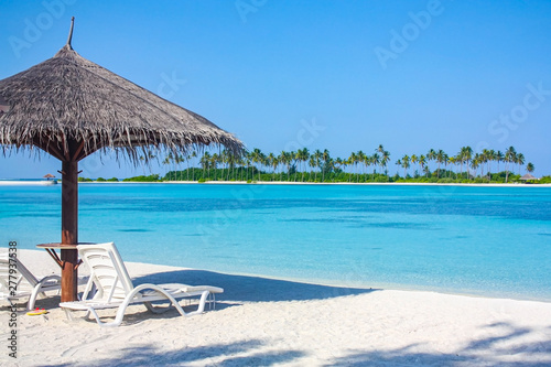 Beautiful paradise landscape of Maldives. beach with white sand and blue water, with a place to relax on the loungers