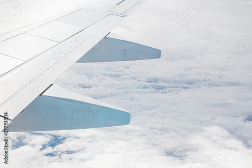 Wing of aircraft is flying. Sky background,bright daylight. © Stock.Foto.Touch