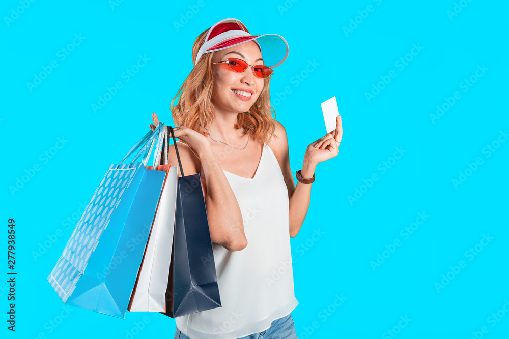 Asian Woman shopping in the mall with bags and credit bank card. Shopaholic and black friday sale concept Asian Woman shopping in the mall with bags and credit bank card. Shopaholic and black friday sale concept