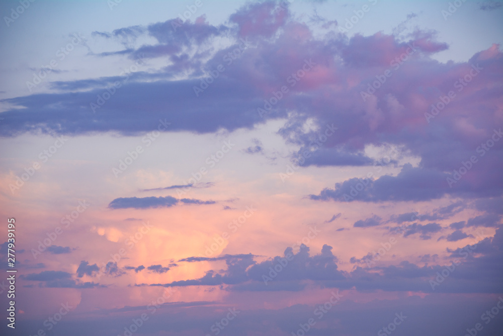 Background of a pink and purple sky at sunset.