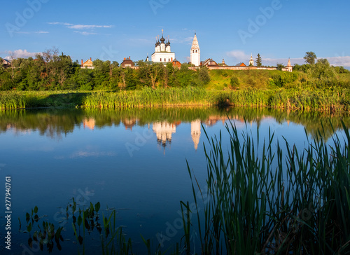 Reflection in the water of an ancient monastery in the city of Suzdal. The beauty of the Russian province.