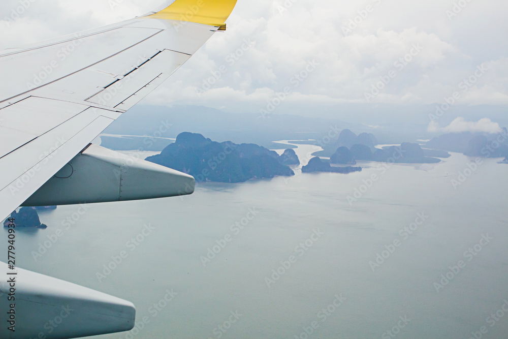 High angle view on plane Thailand At daytime,view from the plane window mountains and sea near Phuket Island. High angle view on plane Thailand At daytime,view from the plane window mountains and sea near Phuket Island.