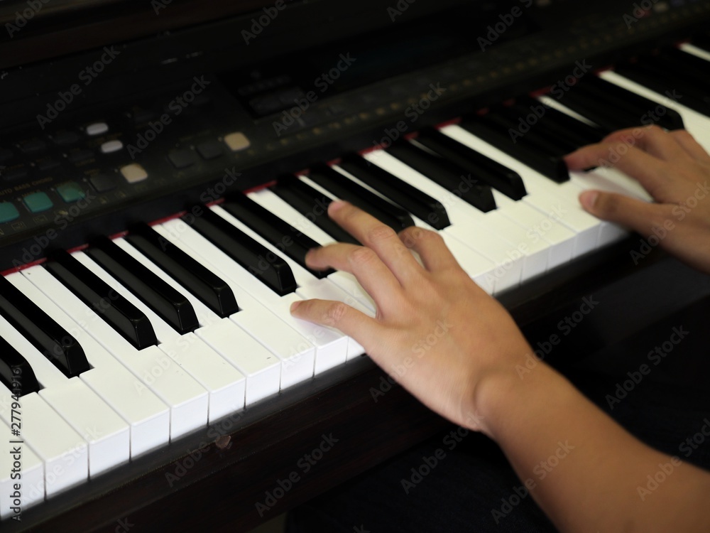 Hands playing music on the piano Hands playing music on the piano