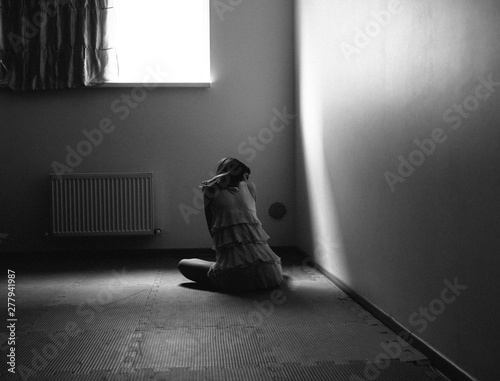 female silhouette on the floor by the window