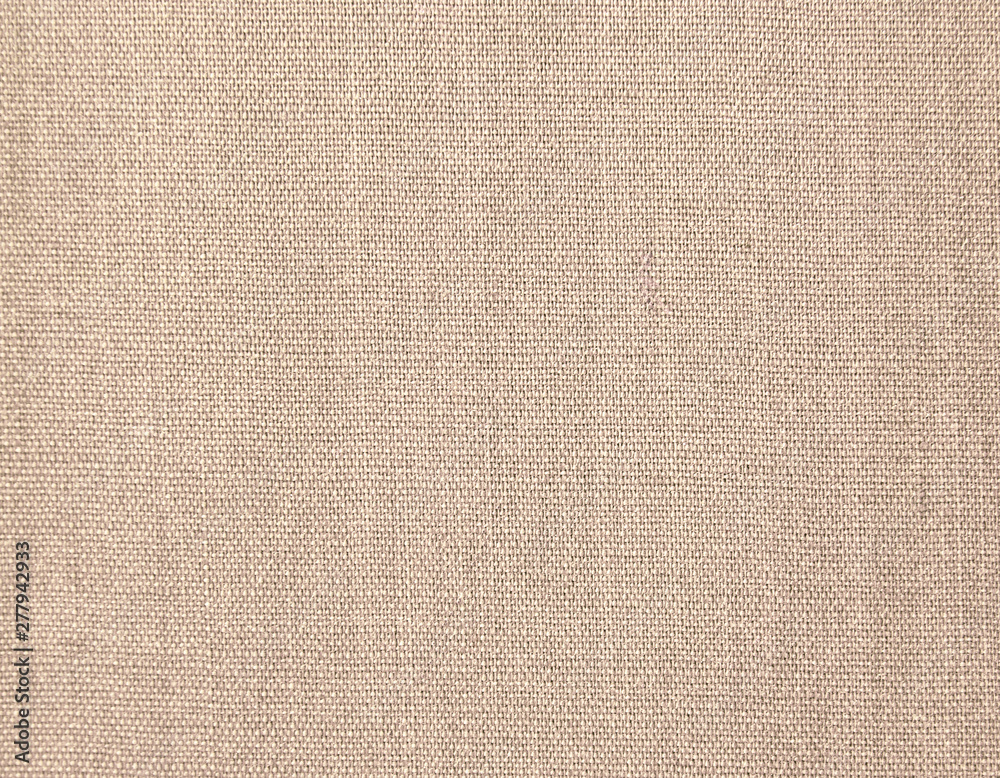 Textured background of beige natural textile Textured background of beige natural textile