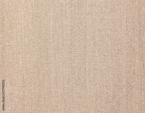 Textured background of beige natural textile 