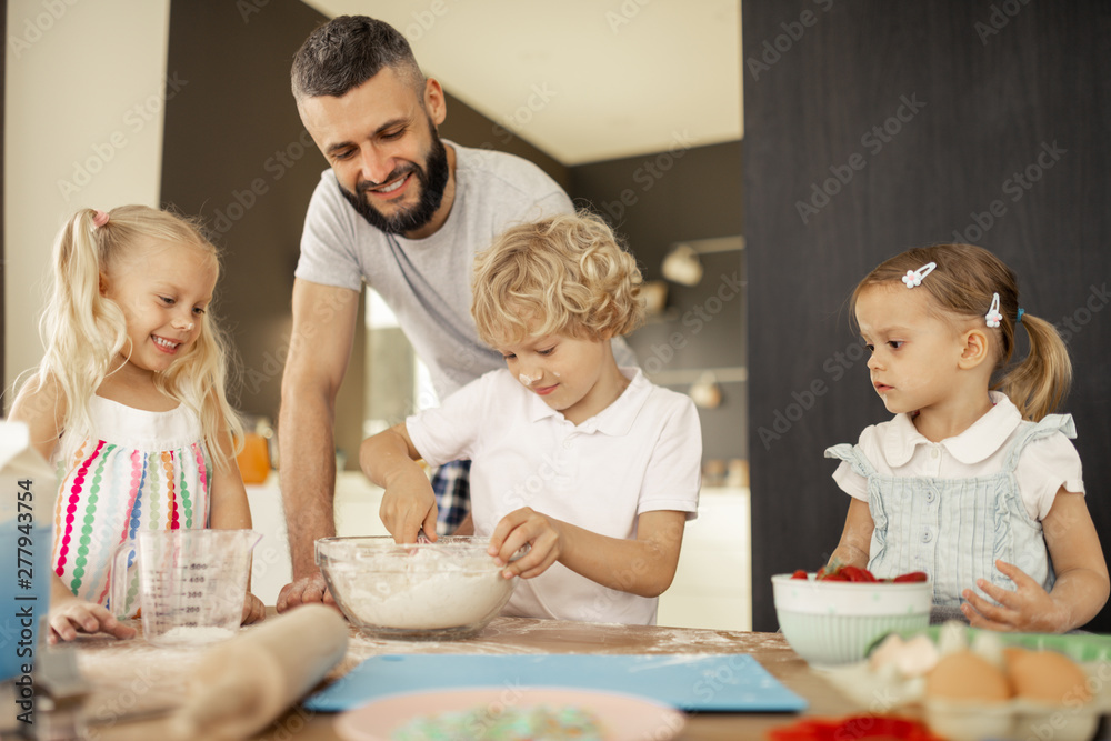 Nice bearded man standing behind his son Nice bearded man standing behind his son
