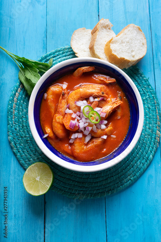 Mexican shrimp soup on blue background