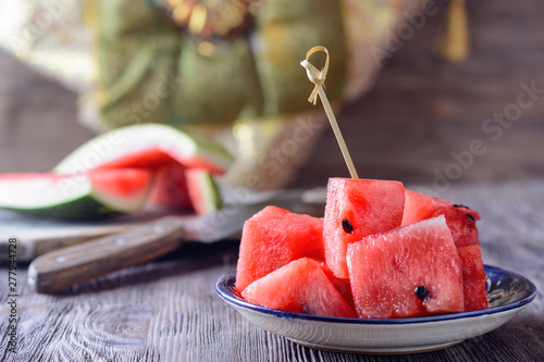 Ripe red watermelon is cut into small portion without skin and ready to eat